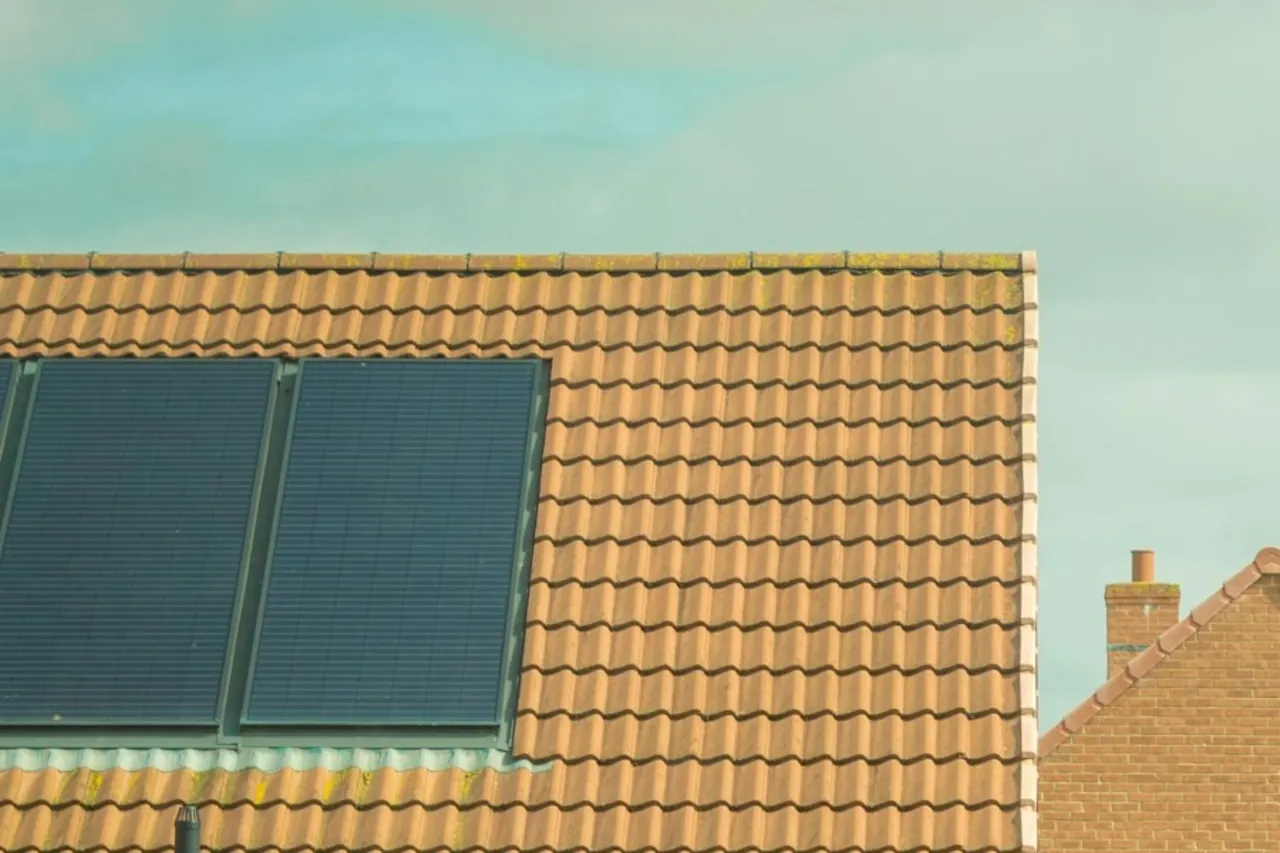 Solar panels on the tiled roofs of brick houses in England